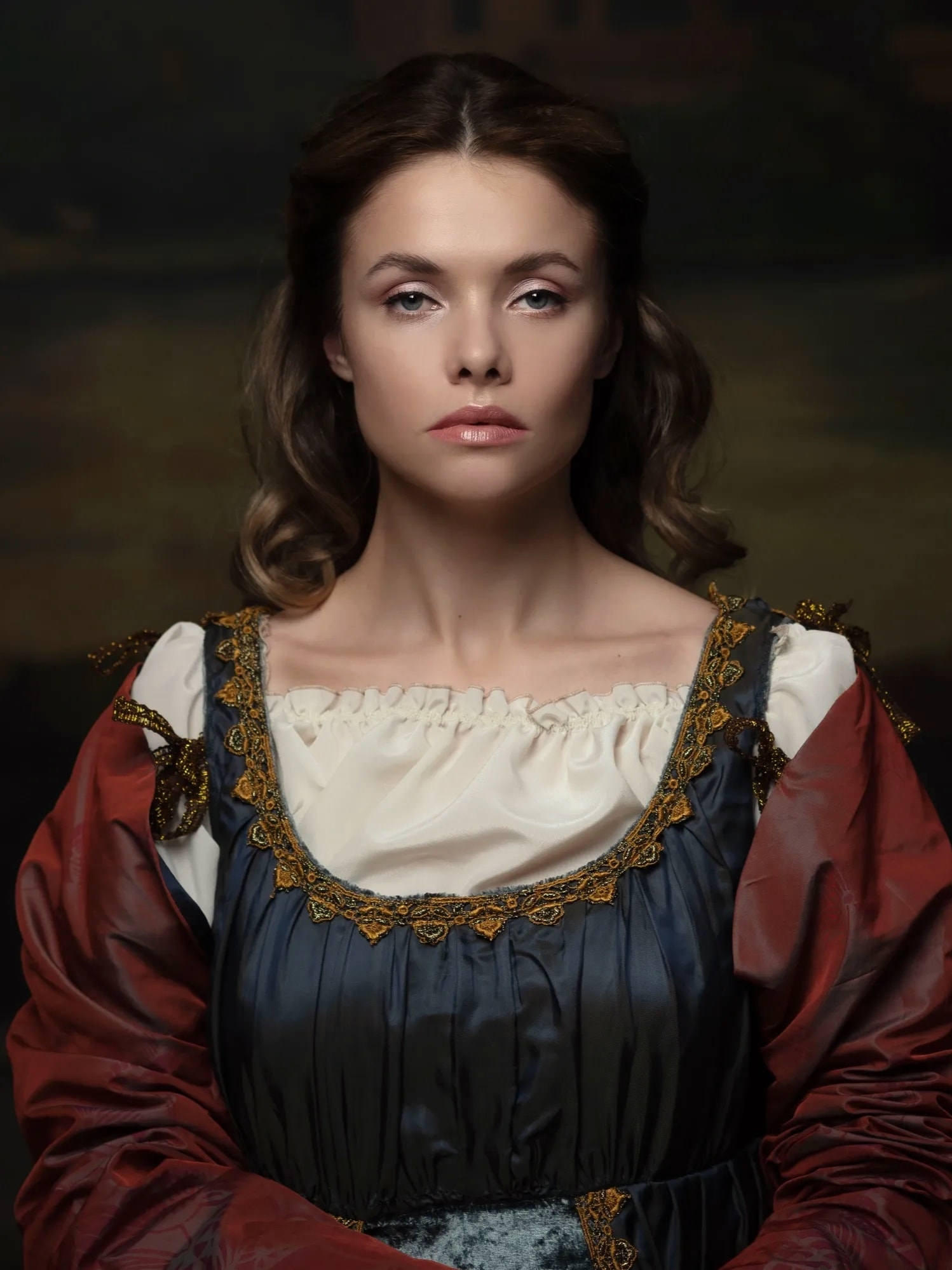 Renaissance portrait of a woman with warm brown eyes and pearl earring